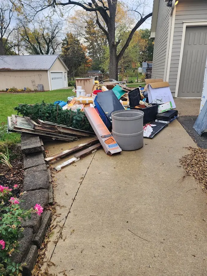 Dumpster being loaded with debris for Estate Cleanout Dumpster Rental in Clinton